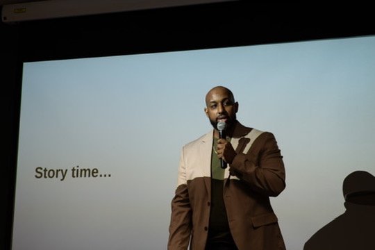 Yaphet on stage at the Awaken To Impact conference